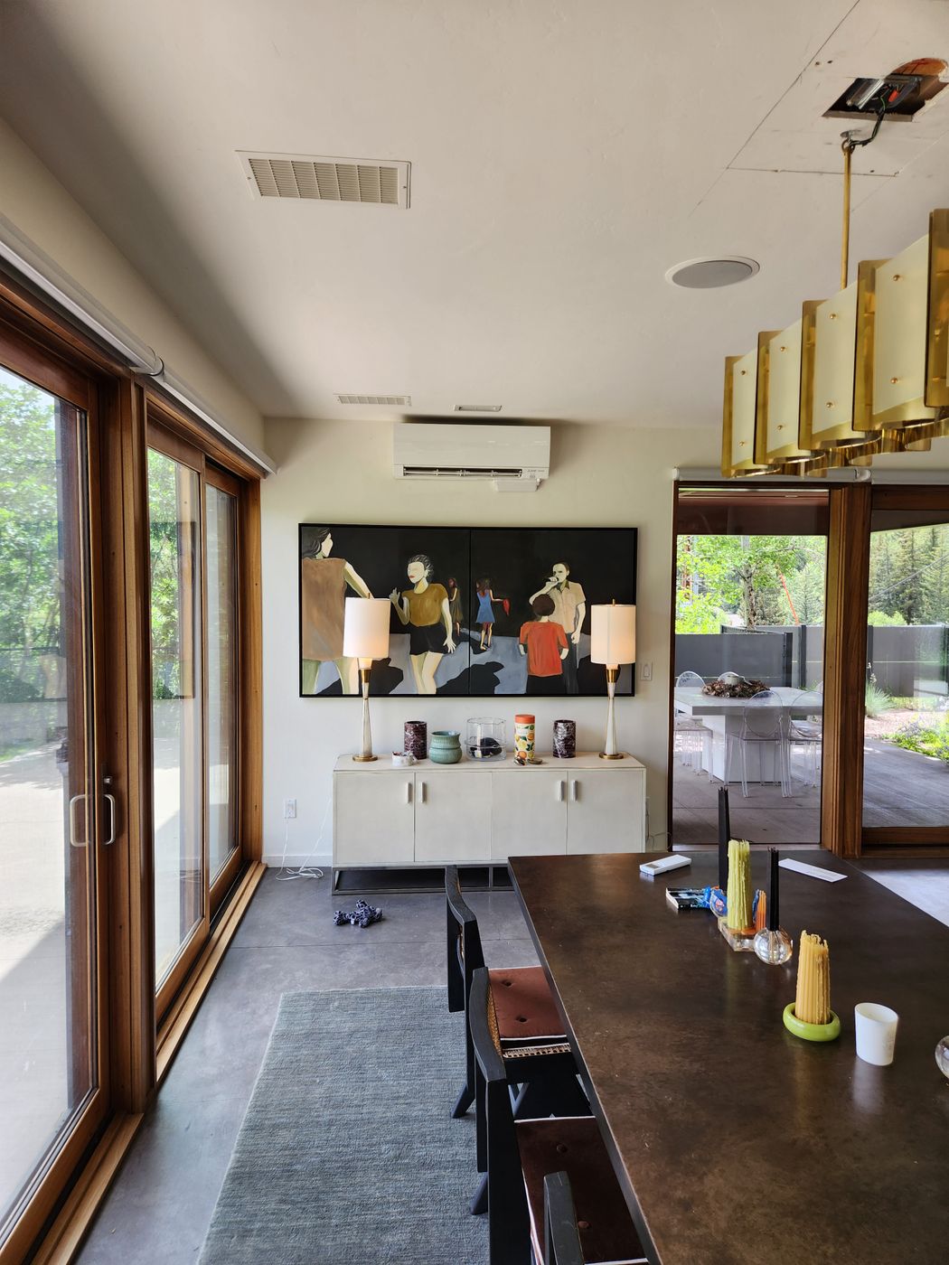Dining room in a modern Aspen home with a mini-split head mounted above the artwork