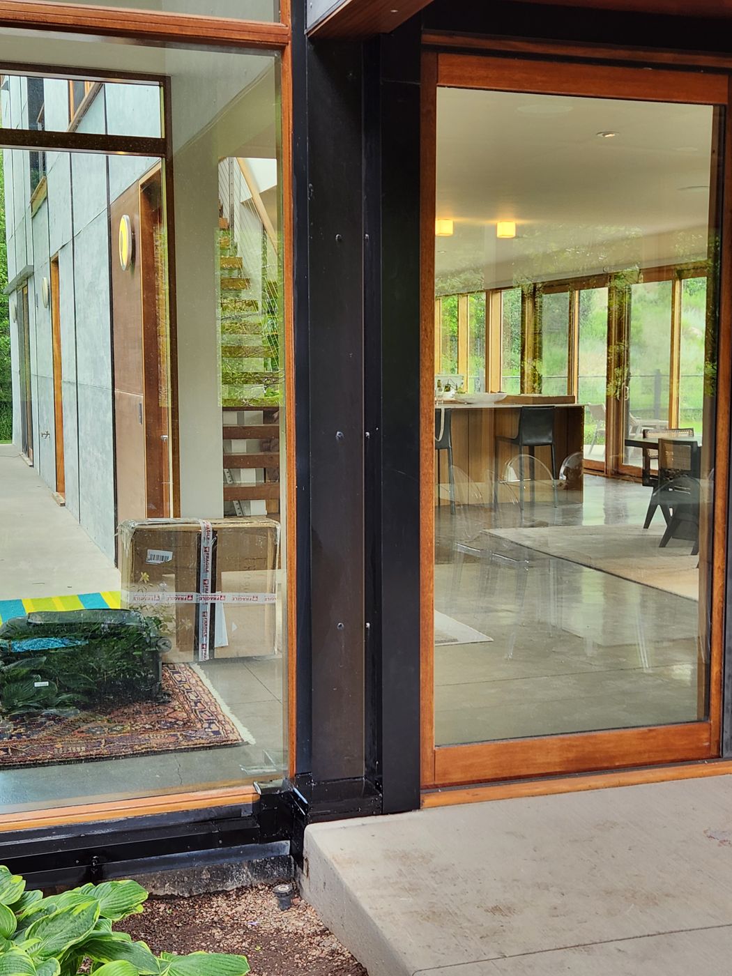 Line hide channel following the black steel frame of a glass door on a modern Aspen home