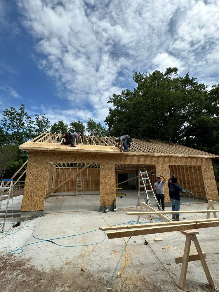 Alpine Homes crew framing a covered porch on a custom build in progress