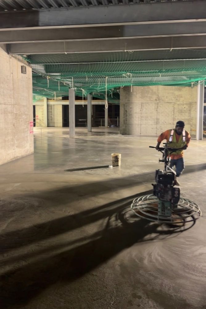 Power trowel finishing an interior concrete slab