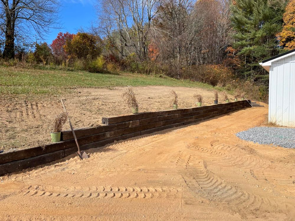 Our Retaining Walls service provides durable and aesthetically pleasing solutions that enhance landscape stability, prevent soil erosion, and create functional outdoor spaces tailored to your home's specific needs. for Old South Grading in Glade Valley, NC
