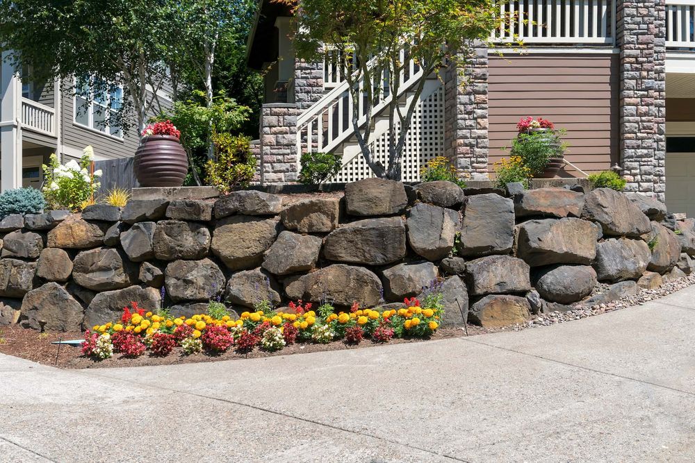 Our Retaining Wall Construction service expertly designs and builds durable retaining walls, enhancing your landscape's stability and beauty while preventing soil erosion with high-quality materials tailored to suit your property’s needs. for Danny Rhodes Trucking & Excavation in Shepherdsville, KY