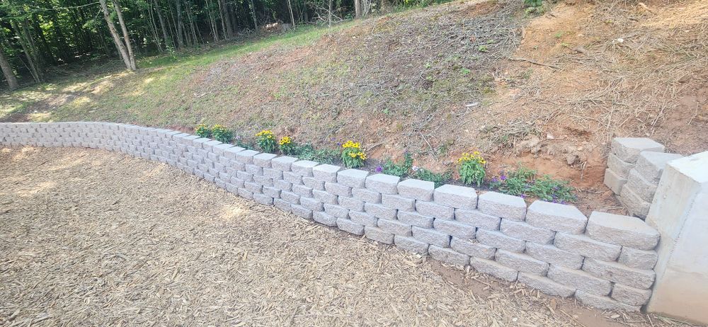 Our Retaining Wall Construction service provides expert design and installation of durable retaining walls to enhance the beauty and functionality of your landscape, ensuring stability for years to come. for JC Landscapers in Ellijay, GA