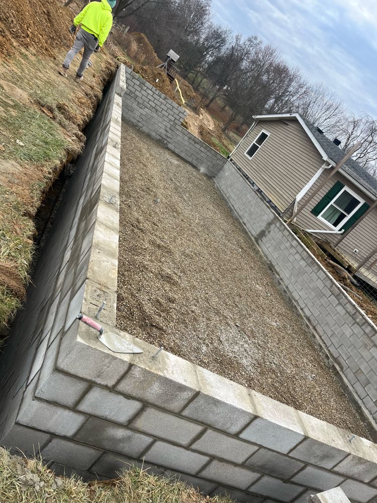 Our Retaining Wall Construction service offers homeowners a durable and aesthetically pleasing solution to prevent soil erosion and create functional outdoor spaces for their property. for Shamblin Masonry & Restoration in Columbus, Ohio