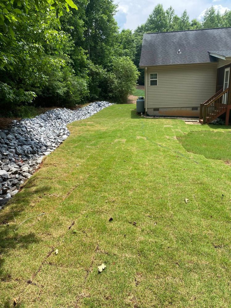 Enhance your outdoor space with our Rock Beds service, offering durable and aesthetically pleasing rock installations that reduce maintenance needs while adding natural beauty and texture to your landscape design. for Taylormade Lawn Management in Clarkesville, GA