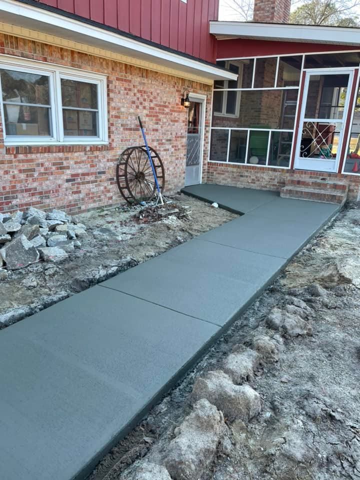 Transform your outdoor space with our expert Sidewalk Installation service. We offer durable, aesthetically pleasing concrete solutions tailored to enhance your home's curb appeal and ensure safe, long-lasting walkways. for Palmetto Precision Concrete & More in Bethune, SC