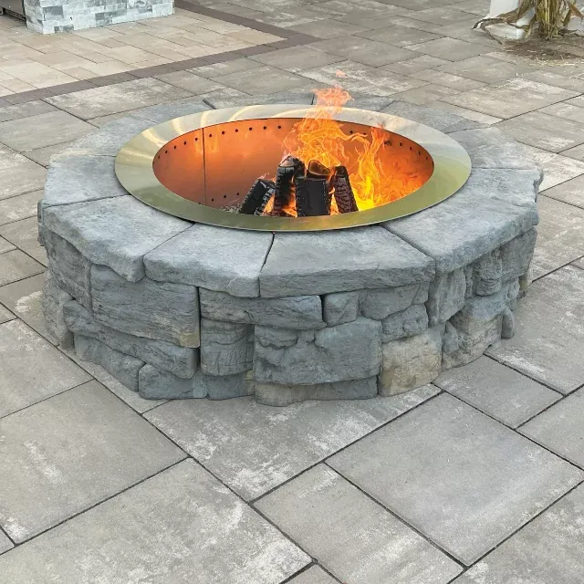 Our custom fire pits transform your backyard into a warm, inviting gathering space, blending beauty, durability, and expert craftsmanship to enhance outdoor living with safe, functional hardscaping tailored to your home. for Wildwood Landscaping in Leominster, MA