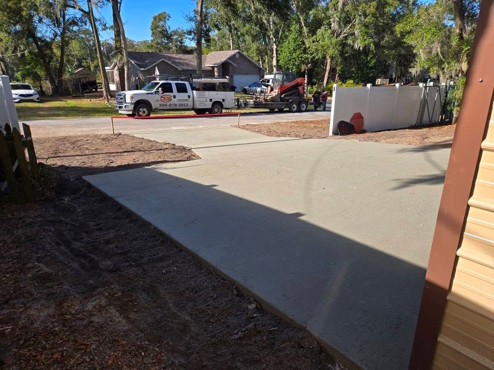 Transform your home's exterior with our expert stamped concrete installation service, providing durable and stylish driveways that enhance curb appeal while offering long-lasting functionality for all your vehicle needs. for Downer Site Services in Sanford, FL