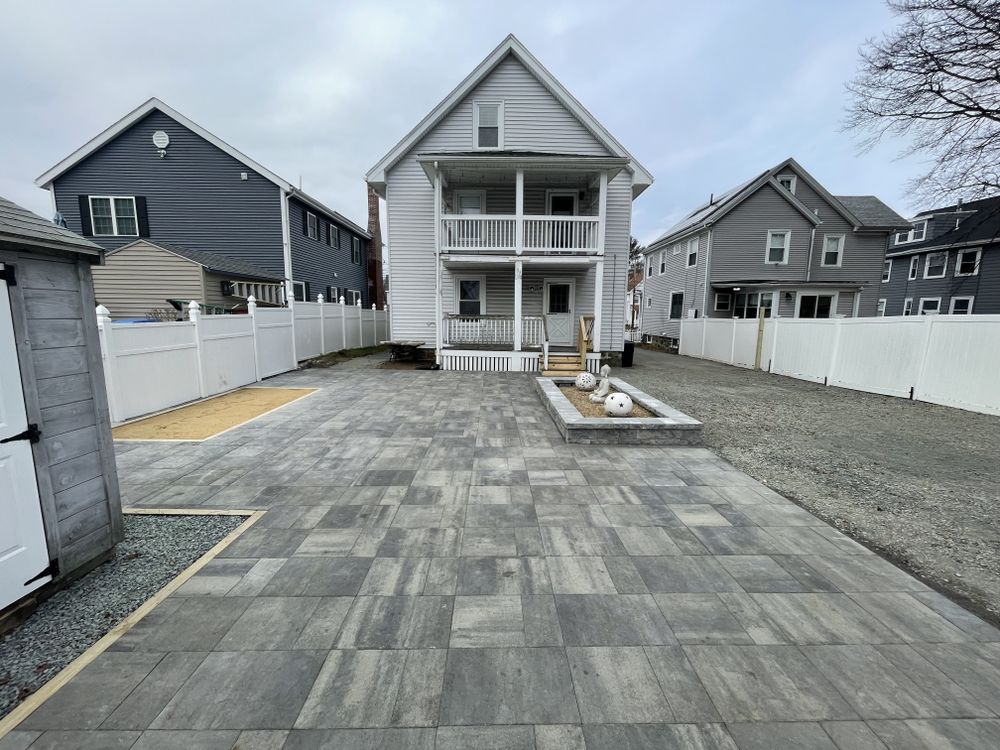 Enhance your outdoor living space with our expert Patio Design & Construction service, transforming your backyard into a beautiful, functional area perfect for relaxation and entertaining family and friends. for Quest Landscapes in North Attleborough, MA