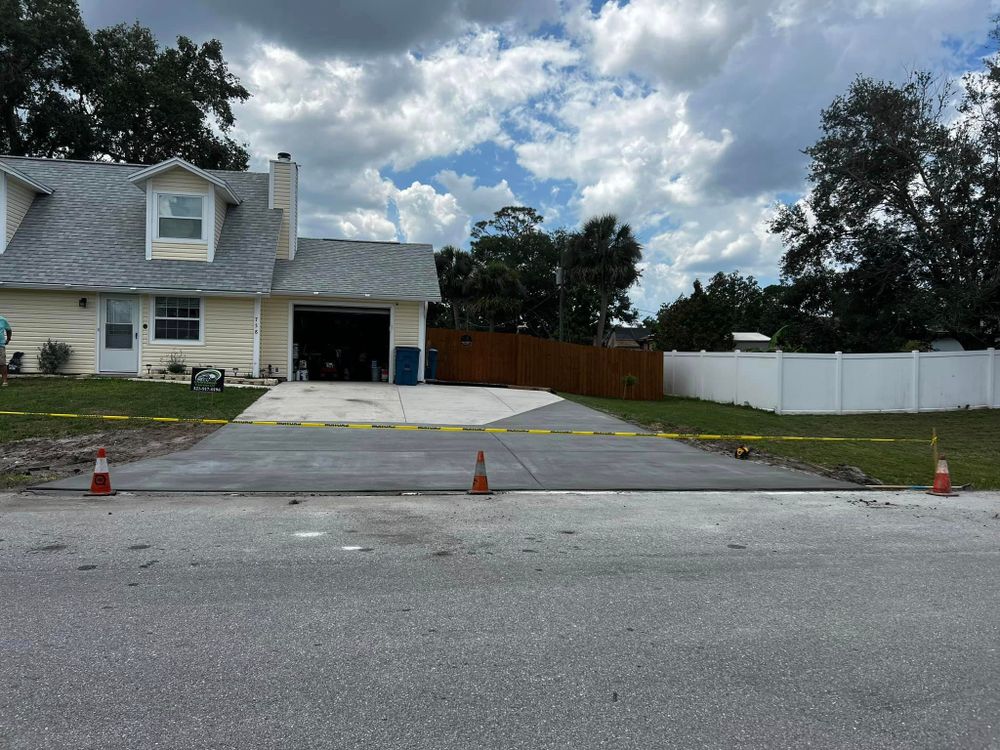 Our driveway repair and replacement service offers homeowners a reliable solution for fixing or upgrading their existing driveways, ensuring durability and enhancing the overall aesthetic appeal of their property. for Green Hammer Concrete in Palm Bay, Florida