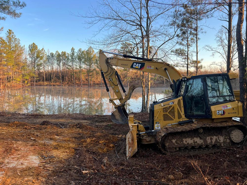 Enhance your property with our Pond Construction service; we expertly clear land, ensuring optimal space and drainage for a beautiful pond while preserving access for driveway installation. for Mud Creek Vegetation Management in Russellville, AL