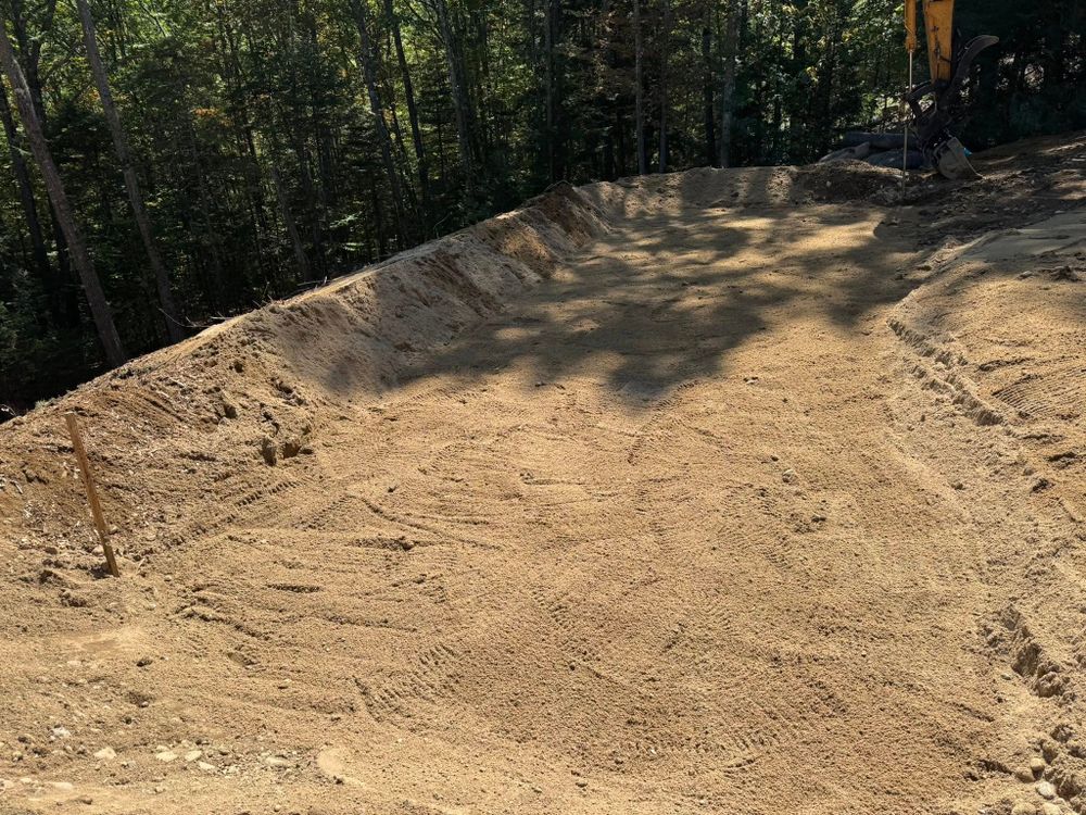 Our House Lot Clearing service expertly prepares your land by removing trees, debris, and unwanted structures, creating a clean slate for new construction while ensuring environmental responsibility and customer satisfaction. for AFH Earthworks in Madison, NH