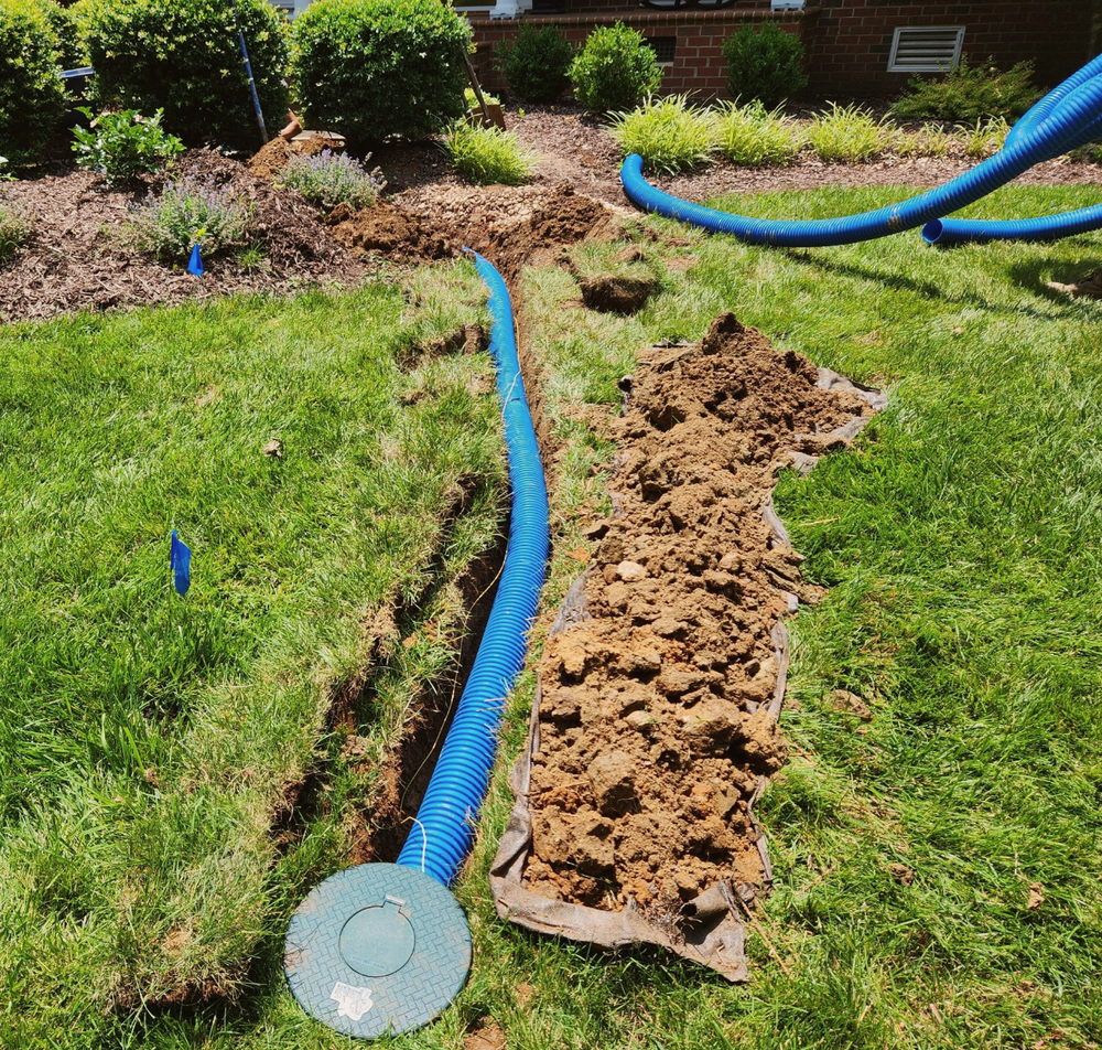 Our Lawn Drains service helps prevent water pooling and flooding in your yard by installing efficient drainage systems, ensuring optimal soil conditions for a healthy and beautiful landscape. for Drain My lawn in Monroe, NC