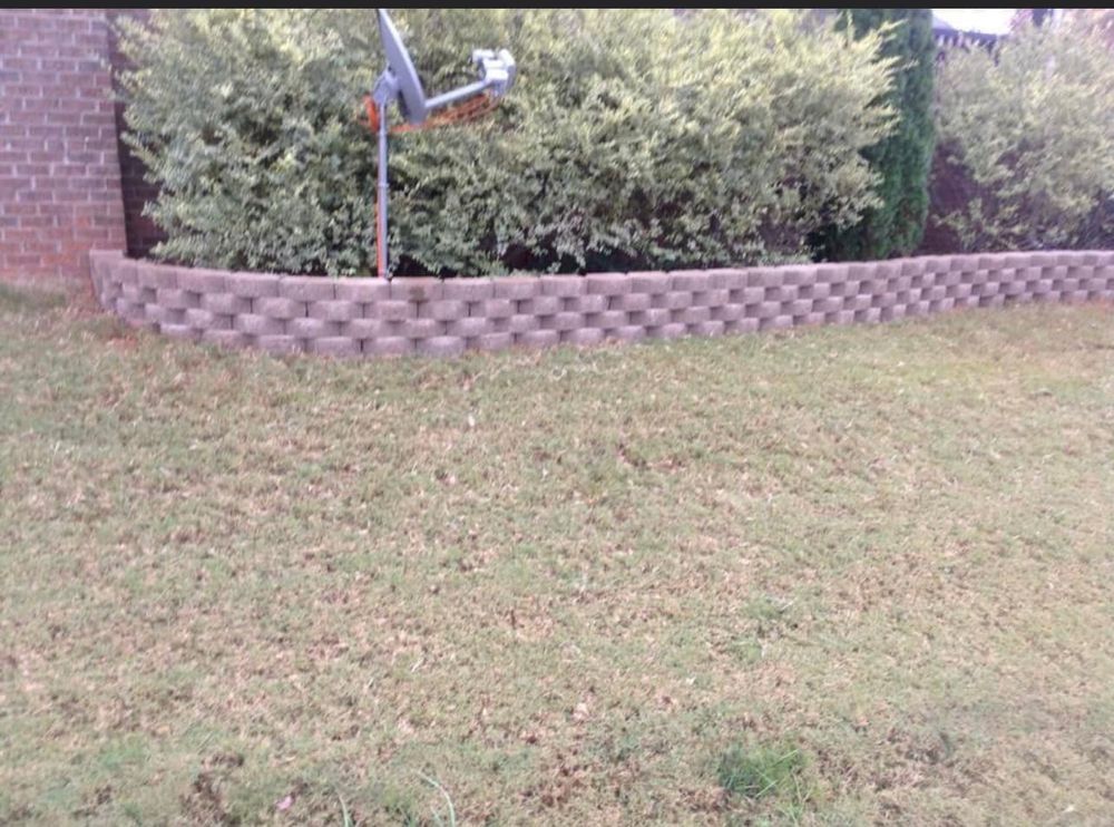 Our retaining wall construction service offers durable, aesthetically pleasing solutions to enhance your landscape, prevent soil erosion, and maximize space utilization, ensuring stability with expert craftsmanship tailored to your home's unique needs. for Simmons Masonry & Concrete in Charlotte, NC