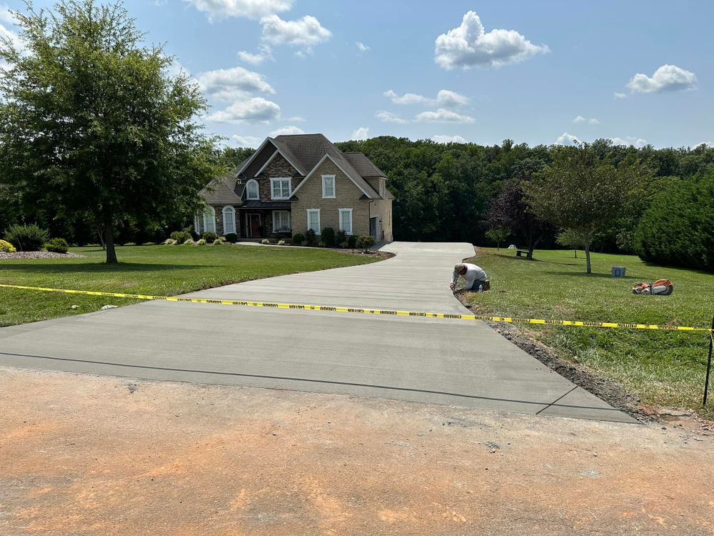 Transform your home's exterior with our professional Driveway Design & Build service, offering customized concrete solutions that enhance curb appeal and provide long-lasting durability for your driveway needs. for Whorley Concrete Construction in Goode, VA