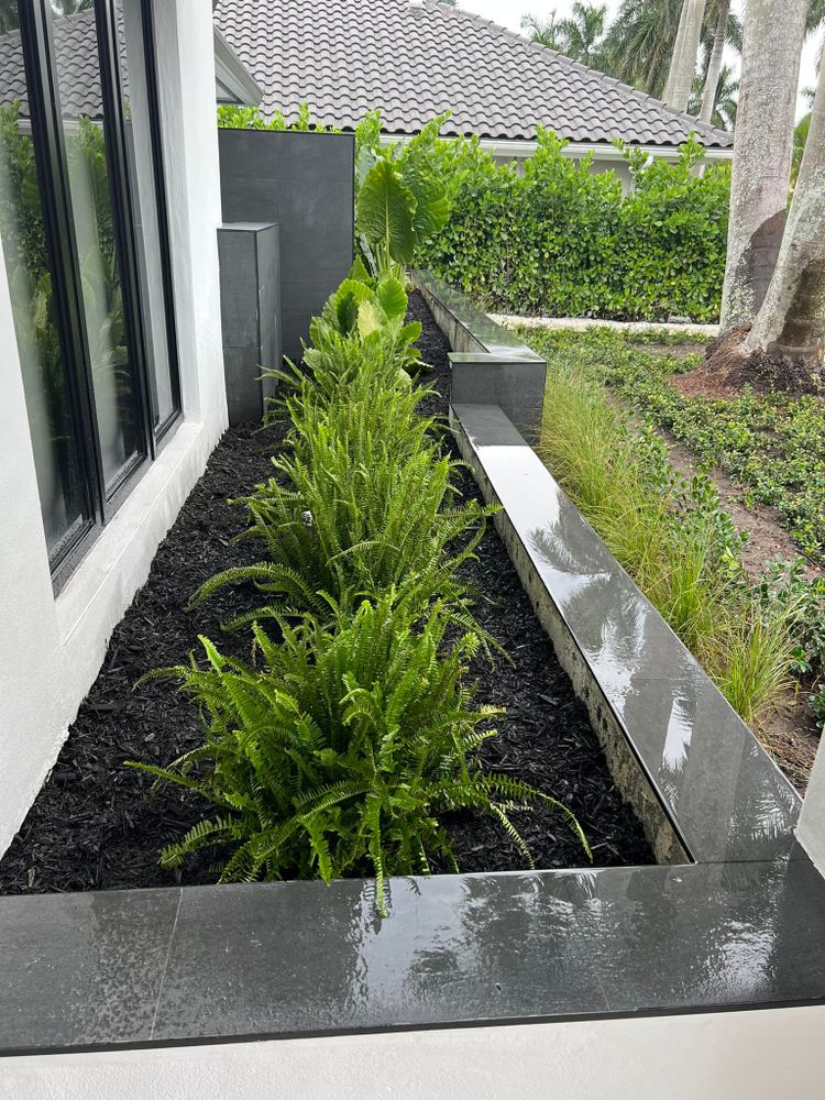 Enhance your garden with our professional mulch installation service, designed to improve soil health, retain moisture, and suppress weeds while adding an elegant touch to your landscape's aesthetic appeal. for An Extravagant Landscape & Lawn Service in Delray, FL