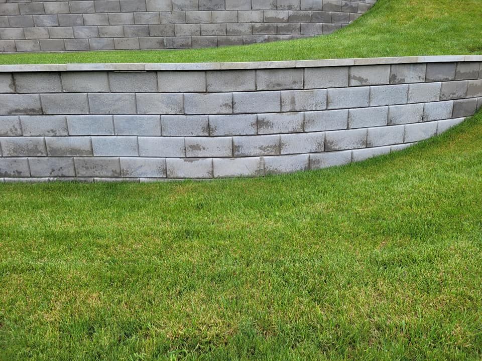 Our Retaining Walls service provides expertly designed and constructed structures to prevent soil erosion, enhance landscaping, and protect your property's foundation. Trust our team to improve both function and aesthetics. for Brownstone Grading in Perry, IA