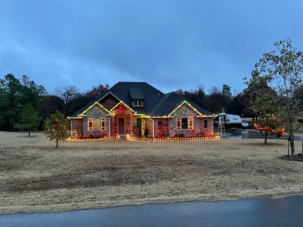 Enhance your home's beauty this holiday season with our professional Holiday Light Installation service. Let us brighten up your landscape with festive lights, while also offering mulch installation for a complete makeover. for Stallion Design And Construction in Norman, OK