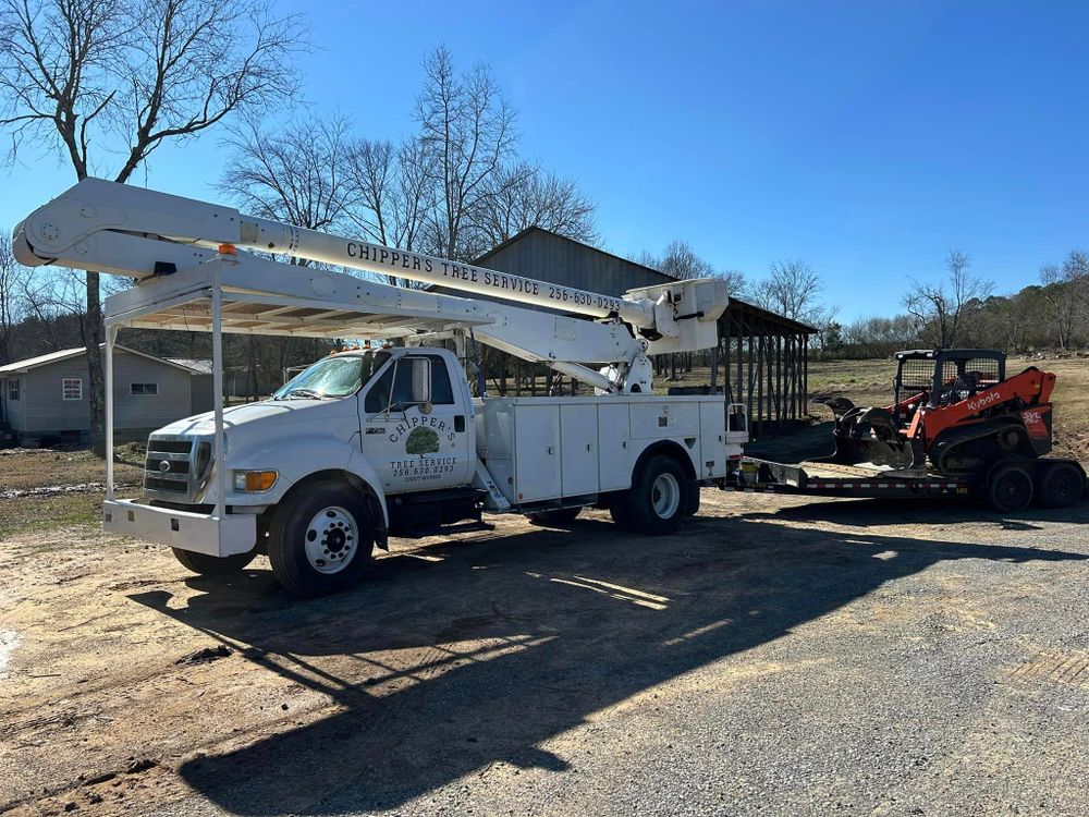 Our professional tree removal service safely eliminates unwanted or hazardous trees from your property, ensuring the safety of your home and landscape while improving overall aesthetics and functionality. for Chipper's Tree Service  in Fort Payne, AL