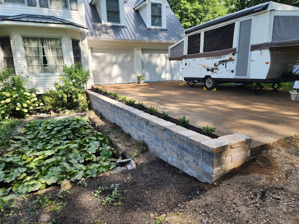Our retaining wall construction service enhances your landscape's functionality and aesthetic appeal, providing durable solutions for erosion control while transforming outdoor spaces into beautifully structured environments. for Dustins Lawncare and Landscaping in Lawrenceburg, TN