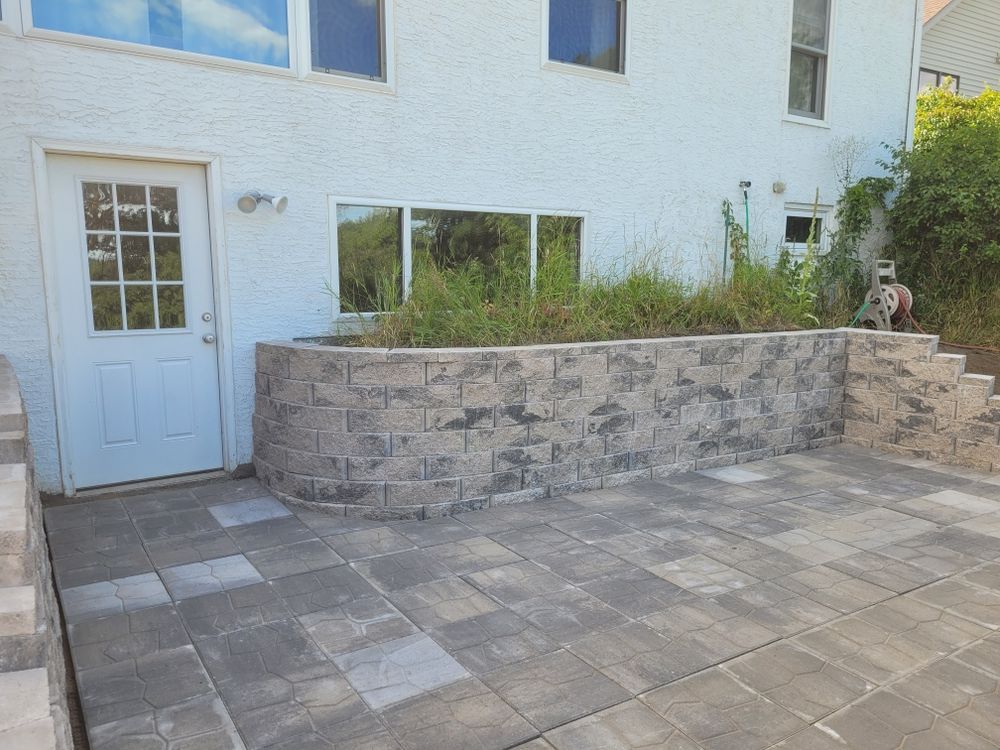 Our Retaining Wall Construction service provides expert design and installation of durable retaining walls to enhance the beauty and functionality of your landscape, ensuring stability for years to come. for Pro-Care LLC in Hudson, WI