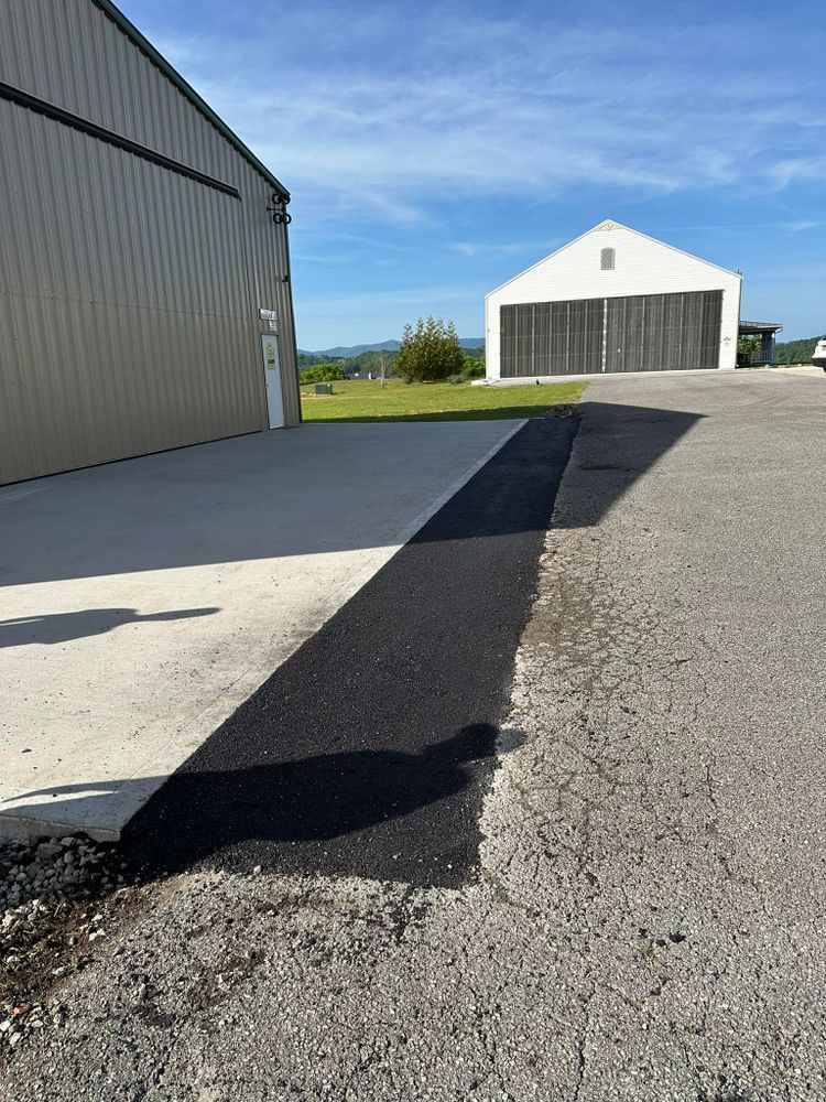 Revitalize your driveway with our asphalt patching service, expertly repairing cracks and potholes for a smooth, durable surface that enhances curb appeal and ensures long-lasting protection against further damage. for Metzler Paving and Sealcoating in Jacksboro, TN