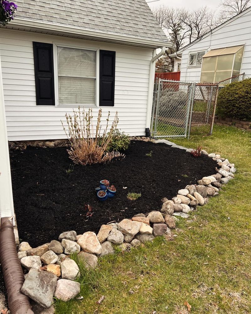 Enhance your landscape's health and aesthetics with our professional mulching service, offering rich, organic coverage that retains moisture, suppresses weeds, and improves soil quality for a vibrant outdoor environment. for Russo’s Landscaping & Tree Removal in Levittown, PA