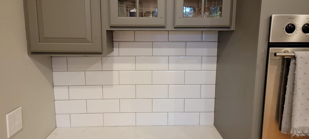 Enhance your kitchen's aesthetics with our expert backsplash tiling service, offering customizable designs and professional installation to create a stunning, durable focal point that complements any style. for Precision Enterprise Construction LLC in Loganville, GA