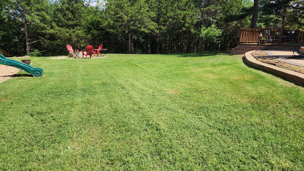 Our Lawn Aeration service involves perforating the soil with small holes to allow air, water, and nutrients to penetrate the grass roots, promoting healthier and more vibrant growth in your lawn. for Mason's Landscaping in Stillwater, OK