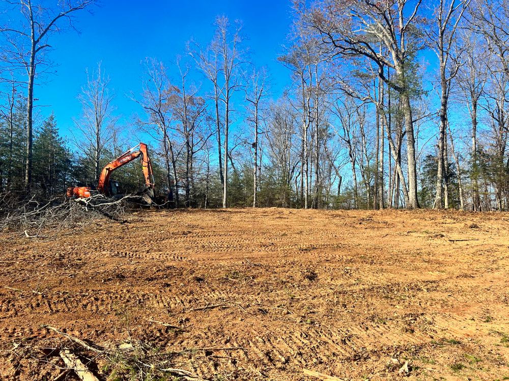 Our Forestry Mulching service efficiently clears overgrown land and vegetation, enhancing property aesthetics and usability while preserving soil health through environmentally friendly practices tailored to your landscape's unique needs. for Heldapay Hauling & Grading in Charlotte, SC
