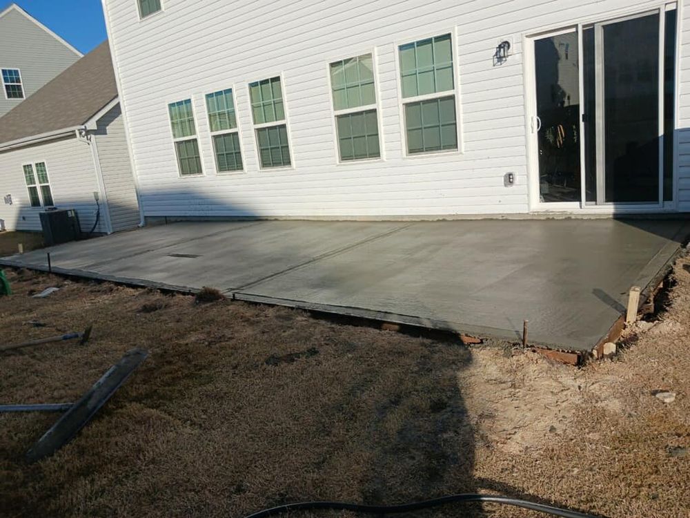 Enhance your outdoor space with our expert Patio Design & Installation services. We offer customized solutions using durable concrete, creating a beautiful and functional area for relaxation and entertaining in your backyard. for Stinson Concrete & Finishing LLC in Rock Hill, SC