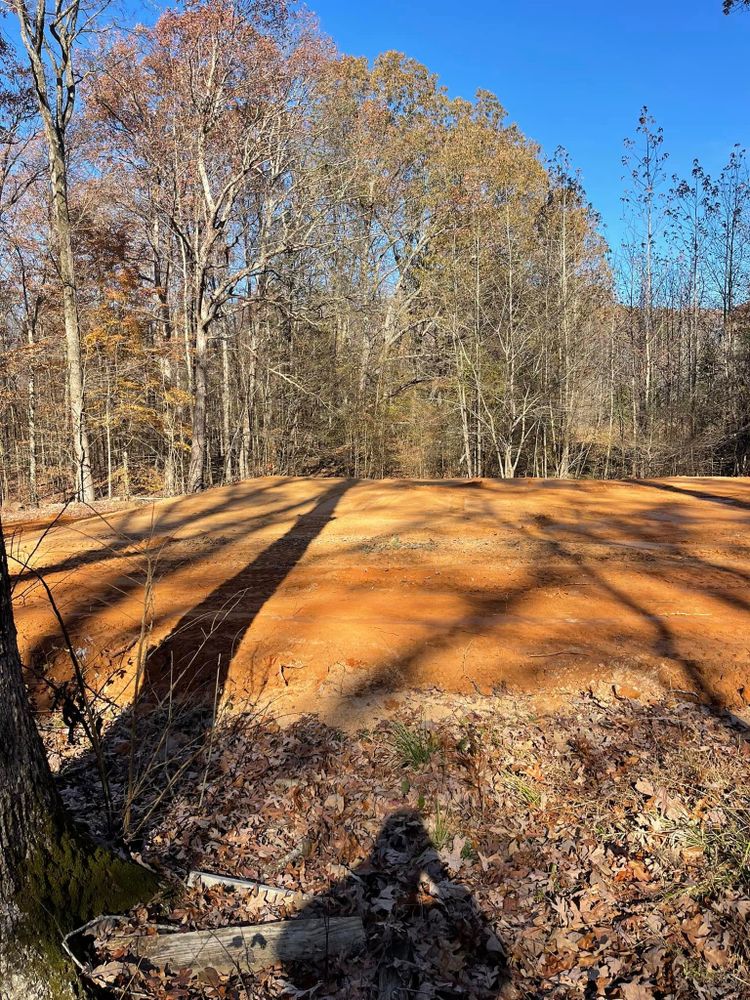 Transform your landscape with our expert land grading services, ensuring proper drainage, improved stability, and a solid foundation for future construction projects. Achieve the perfect setting for your home needs. for Maness Trucking & Excavation in Lexington, TN