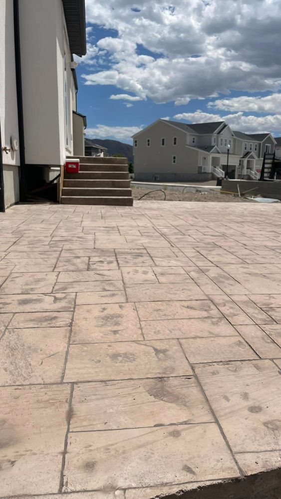 Our stamped concrete installation service enhances your outdoor spaces with durable, aesthetically pleasing patterns and textures, offering a cost-effective alternative to natural stone or pavers while adding value to your home. for Allcrete Concrete & Landscaping in Millcreek, UT