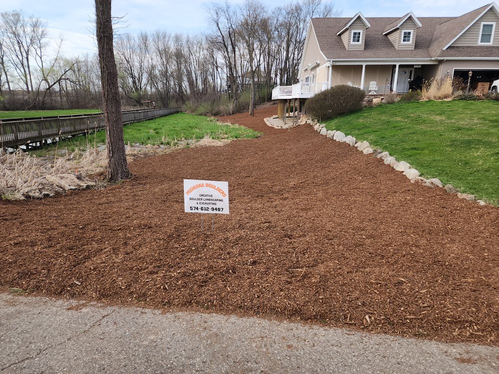 Our Mulch Installation service enhances your garden's health and appearance by retaining moisture, suppressing weeds, and enriching soil. Trust our experts to deliver quality results tailored to your landscaping needs. for Michiana Boulders Landscaping & Excavating in Union, MI