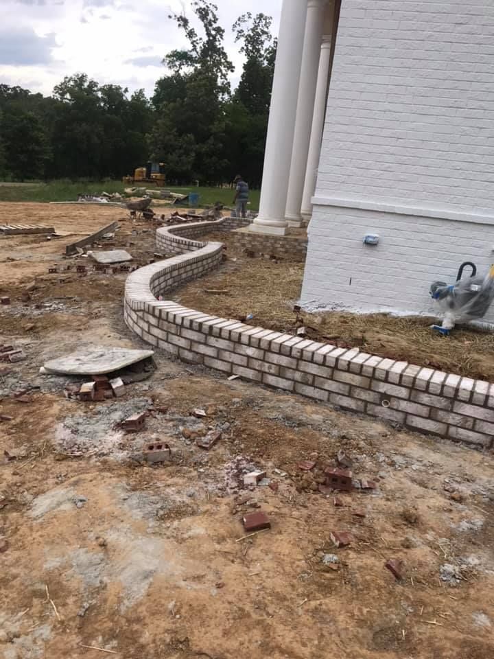 Our Retaining Wall Construction service expertly designs and builds durable, aesthetically pleasing walls to prevent erosion, enhance landscape design, and provide functional outdoor space that complements your home's surroundings. for Modern Masonry & Stone in Germantown, TN