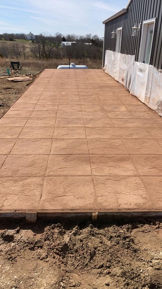 Our stamped concrete installation service adds decorative patterns to boring concrete surfaces, transforming them into visually appealing and durable spaces that enhance your home's curb appeal and outdoor living areas. for Kruse Concrete Construction  in Donnellson, IA