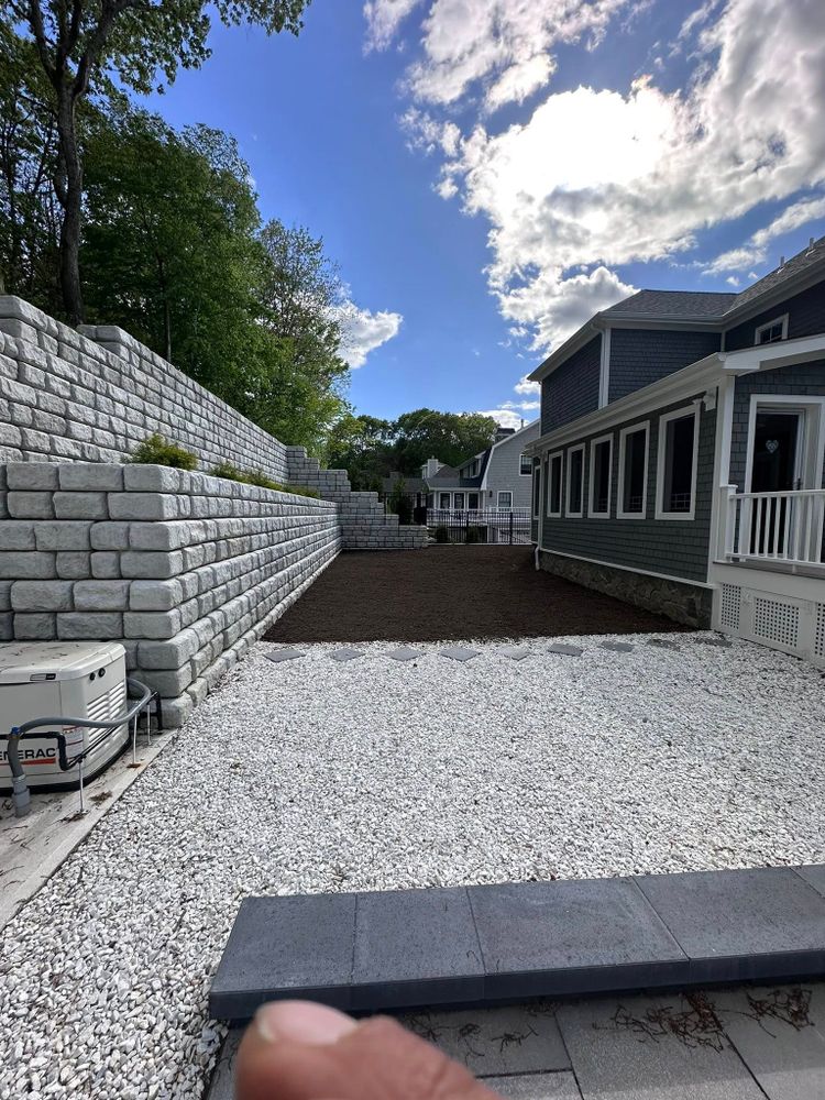 Our retaining wall construction service enhances your landscape's aesthetics and functionality, providing durable solutions to prevent erosion while adding value and beauty to your outdoor space. for Cardinal Landworks LLC in Canterbury, CT