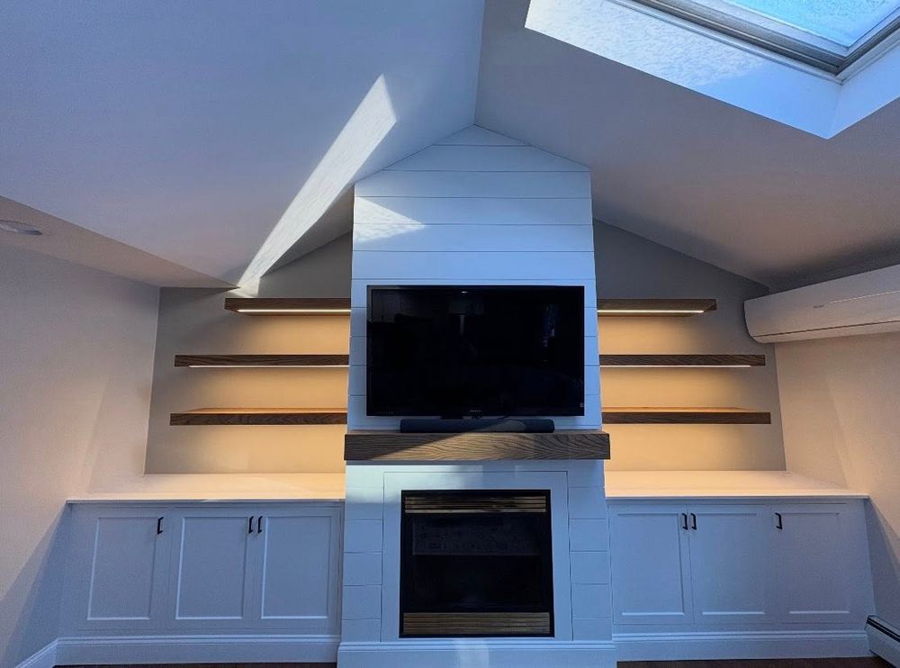 Our bespoke media walls transform your living space with expertly crafted carpentry, seamlessly housing TVs, fireplaces, shelving, and storage to create a stylish, functional focal point tailored to your home. for Kyle Espinola  in Dracut, MA