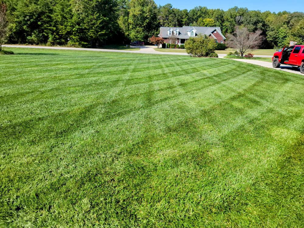 Our Fertilization service nourishes your lawn with essential nutrients, enhancing its health and vibrancy, resulting in a lush and green yard you can be proud of. for Piedmont Lawn and Landscaping in Lexington, NC