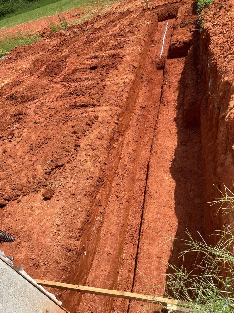 Our Trench Digging service ensures precise, efficient excavation for septic system installation or repair, minimizing disruption to your property while ensuring optimal performance and compliance with local regulations. for Williams Excavating in Statesville, NC