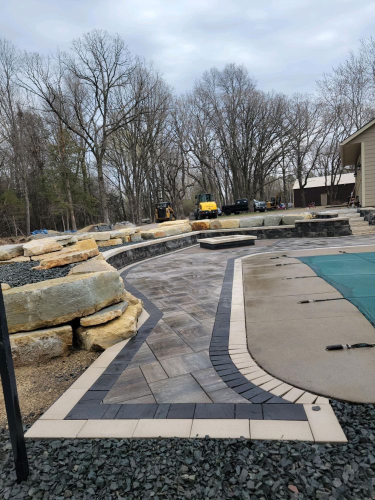 Our Water Walls & Waterfalls service offers homeowners the opportunity to enhance their outdoor spaces with beautiful and customizable water features, adding elegance and tranquility to their landscape. for Boss Construction in Saint Paul, MN