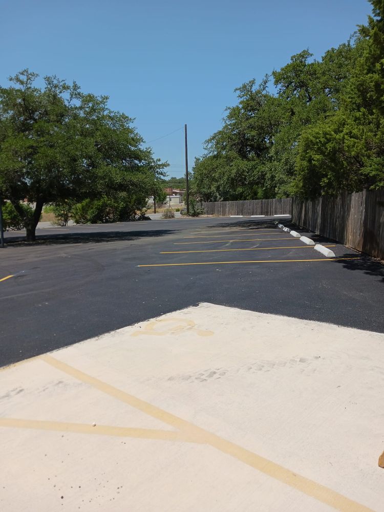 Enhance your driveway's durability with our Seal Coating service, providing a protective layer that shields against weather damage, prevents cracks, and extends the lifespan of your asphalt surface for years. for CAM Paving & Construction in Kendalia, TX