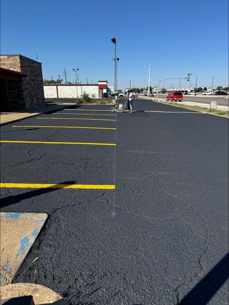 Our Striping service enhances your property's safety and appearance by providing clear, professional line markings for driveways and parking areas, ensuring efficient traffic flow and maximizing usable space. for Adams Asphalt & Sealcoating in Lubbock, TX