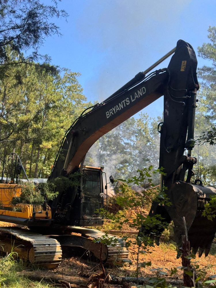 Our Land Clearing service efficiently removes trees, brush, and debris to prepare your property for new construction or landscaping projects, ensuring a clean slate while enhancing the safety and aesthetics of your land. for Bryant's Land Services in Forsyth, GA