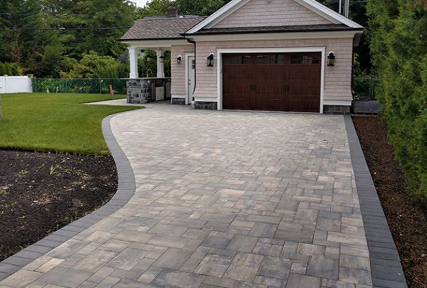 Enhance your home with our expert Paver Driveway service, offering durable and aesthetically pleasing solutions that perfectly complement your roofing choices, ensuring a cohesive and elegant outdoor space. for Rhino Roofing & Masonry in Boston, MA