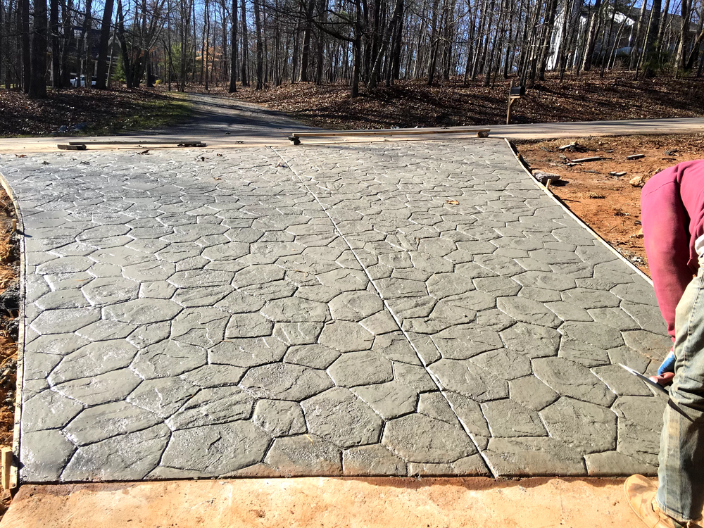 Our stamped concrete installation service transforms your outdoor spaces with durable, beautifully patterned surfaces that mimic high-end materials like stone or brick, enhancing the aesthetics and value of your home. for Canales Construction in Marietta, GA