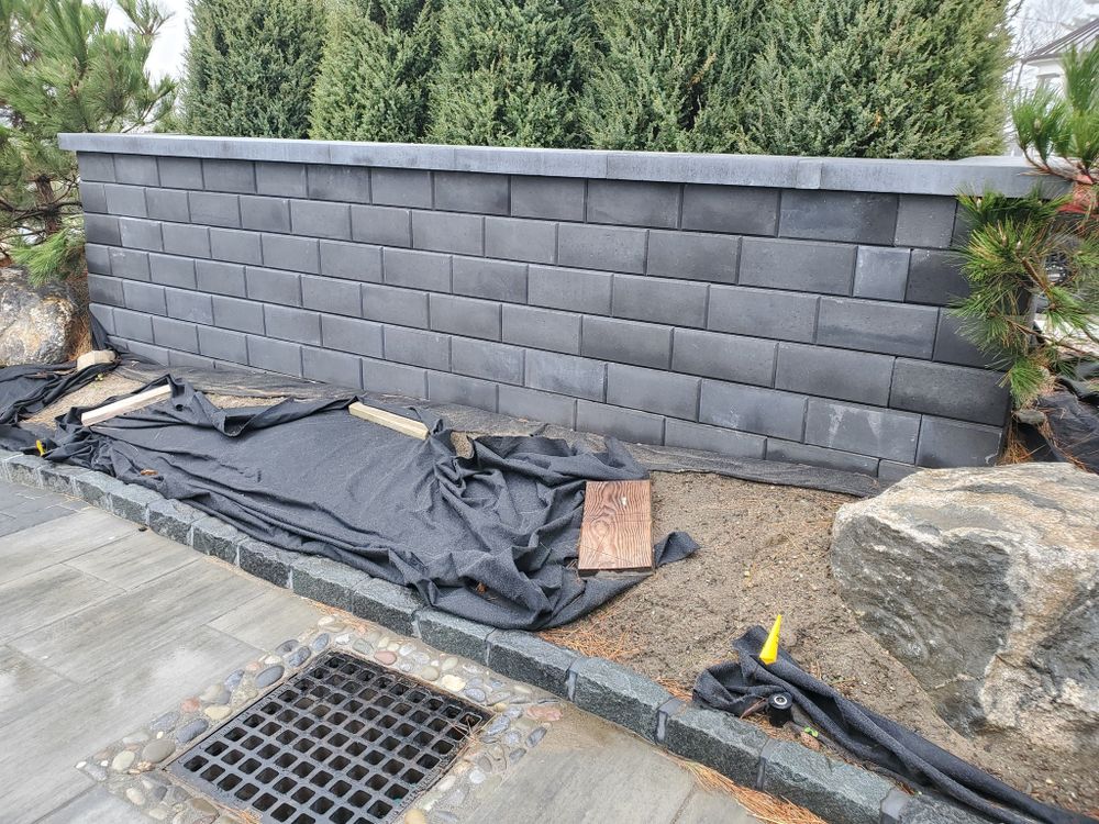 Enhance your landscape's stability and aesthetics with our expert retaining wall construction, providing durable solutions for erosion control while seamlessly blending functionality with design to elevate your outdoor spaces' appeal and safety. for Glen R. Guilman Construction in Goshen, CT