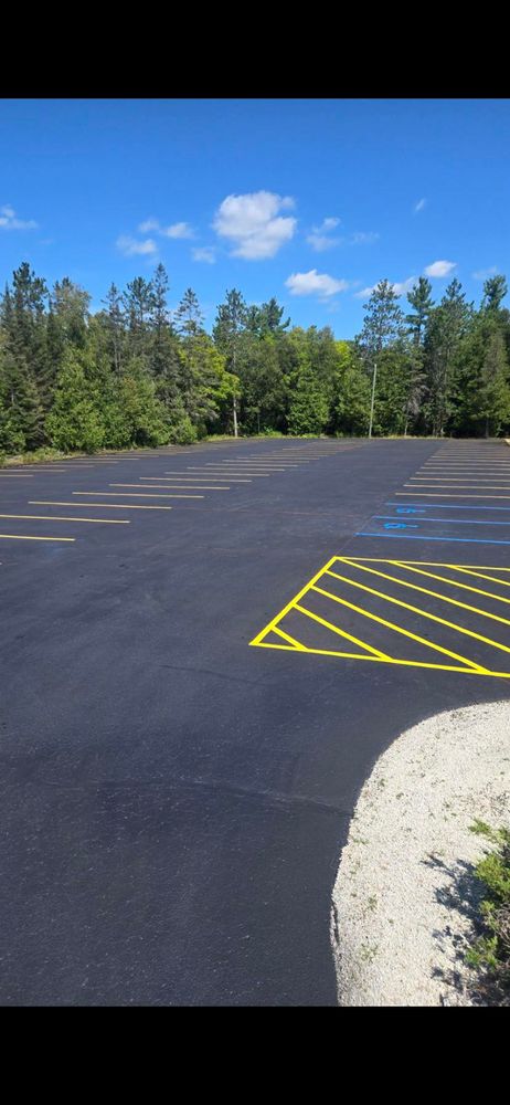 Enhance your driveway's appearance and safety with our professional striping services, offering precise lines and durable materials for clear parking spots, walkways, and decorative designs that ensure long-lasting functionality. for Darkside Sealcoating in Alpena, MI