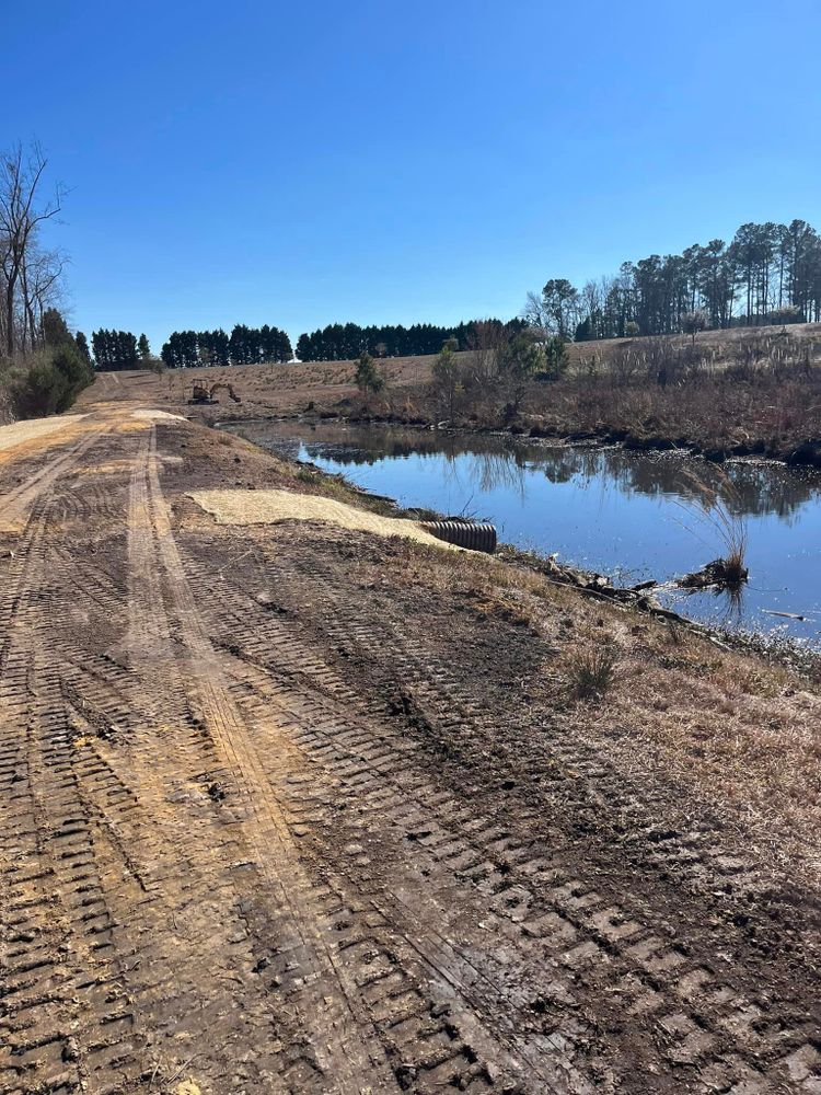 Our Retention Pond Maintenance service ensures your pond is free of debris, well-maintained, preventing flooding. Trust our expertise to keep your property safe from water damage all year round. for SodGods Lawncare and Landscaping in Fayetteville , NC