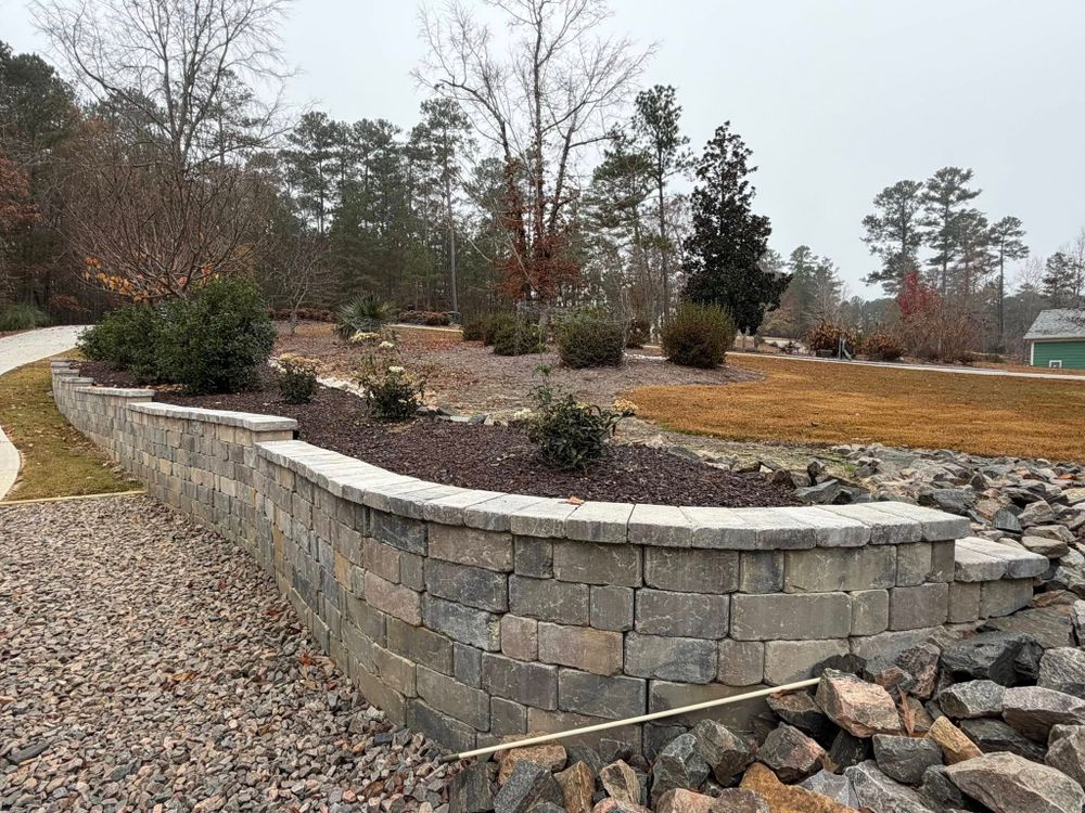 Transform your outdoor spaces with our expert Retaining Wall Construction service, enhancing both functionality and aesthetics. Our skilled team ensures durability and precision tailored to each unique landscape requirement. for Clarks Hill Property Solutions in McCormick, SC